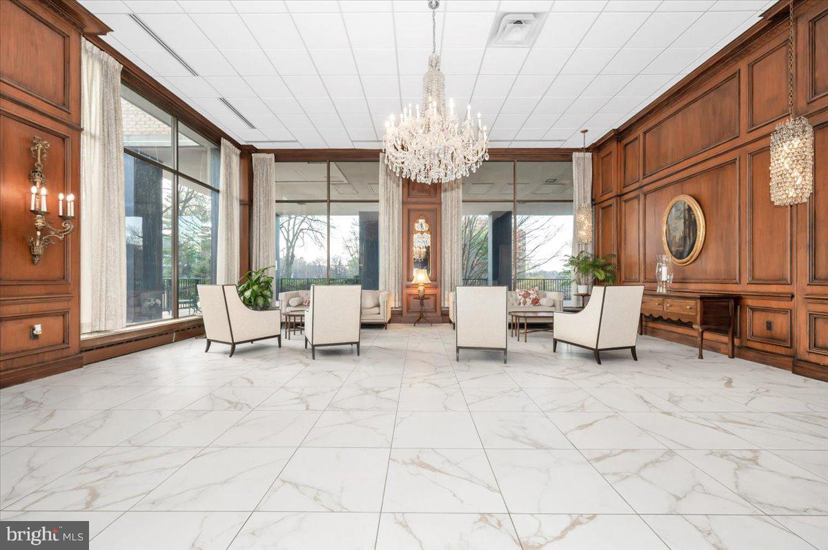 9701 Fields Road, Unit 2206 Gaithersburg, MD 20878 - Photo 3 of 30 a living room with furniture a chandelier and a large window