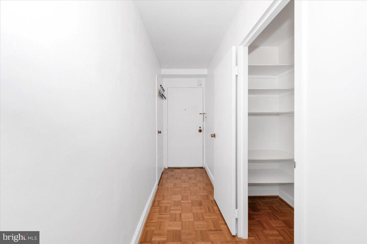 9701 Fields Road, Unit 2206 Gaithersburg, MD 20878 - Photo 6 of 30 a view of a hallway with wooden floor