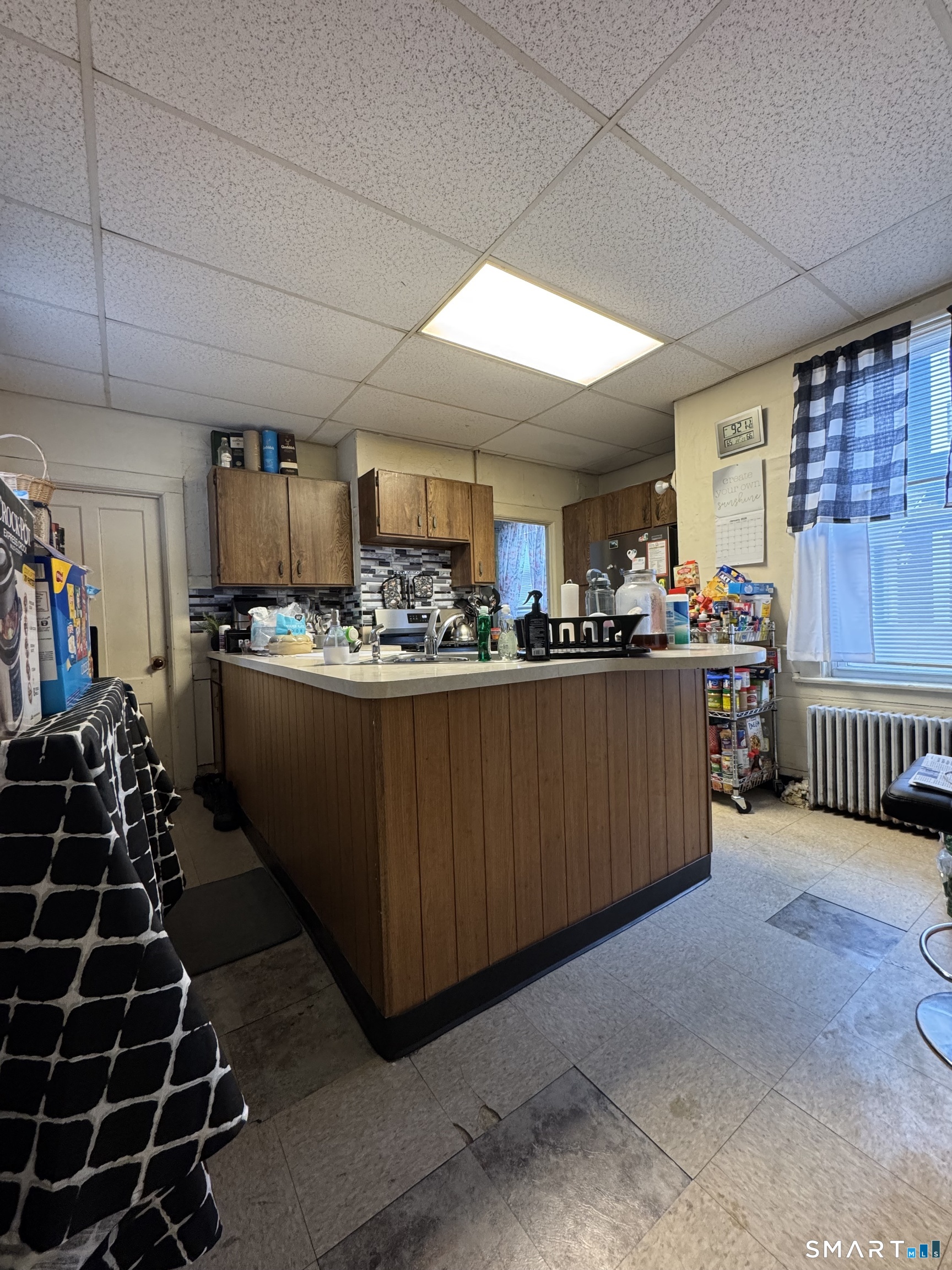 6 Williams Street New London, CT 06320 - Photo 20 of 23 a kitchen with stainless steel appliances a sink a stove a refrigerator cabinets and a dining table