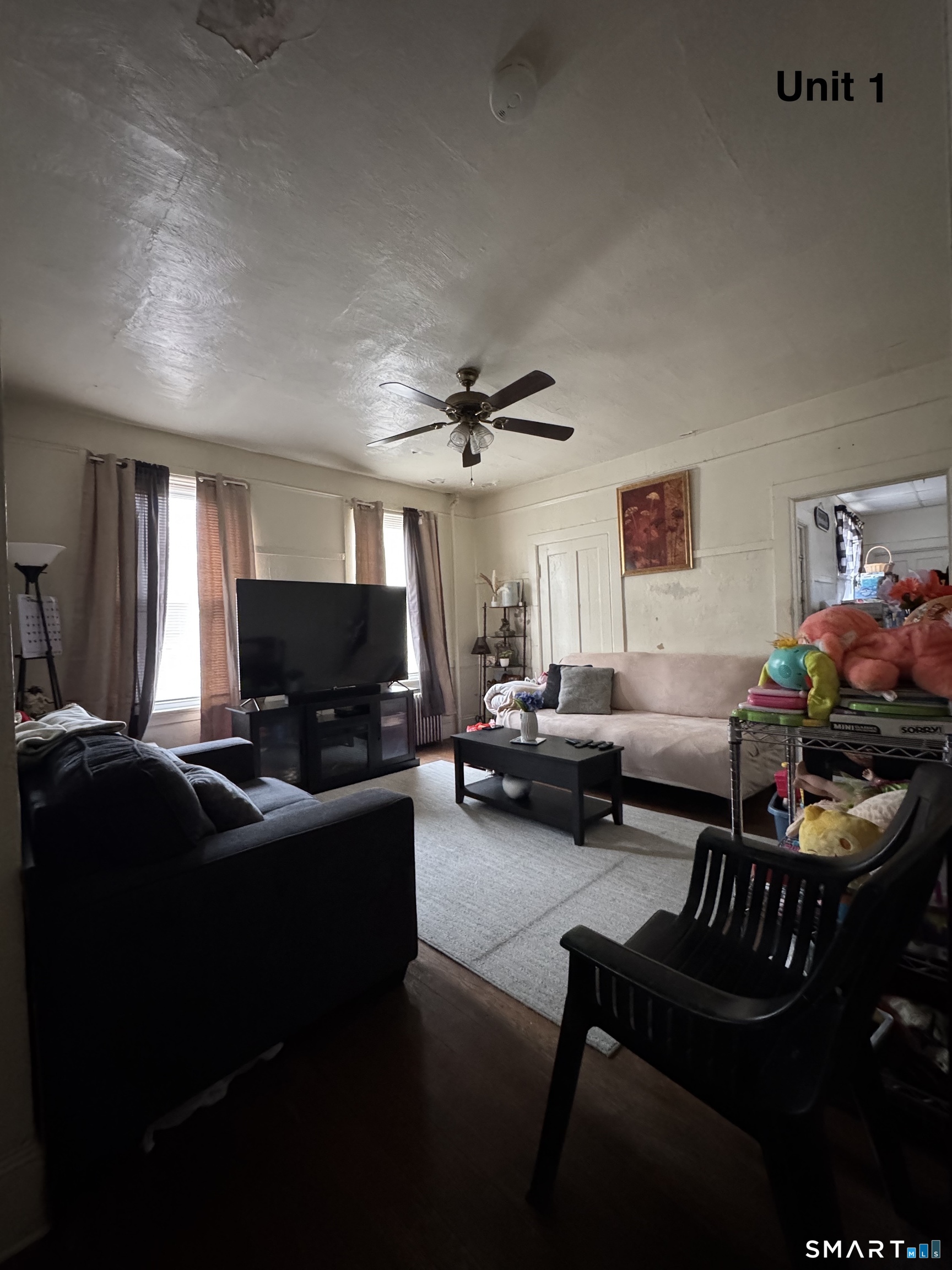 6 Williams Street New London, CT 06320 - Photo 2 of 23 a living room with furniture and a flat screen tv