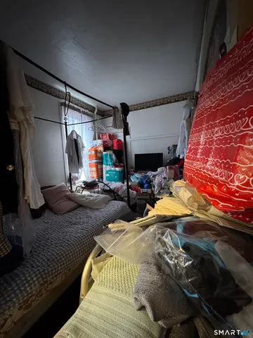 a bedroom with bed and a window