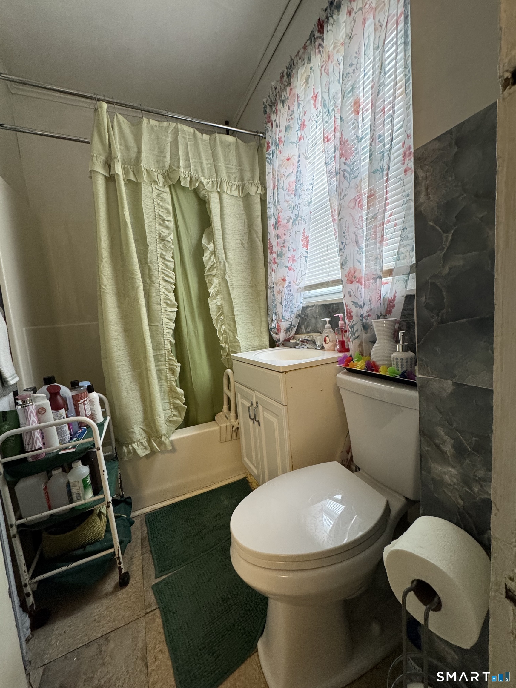 6 Williams Street New London, CT 06320 - Photo 6 of 23 a white toilet sitting next to a bathroom sink and tub