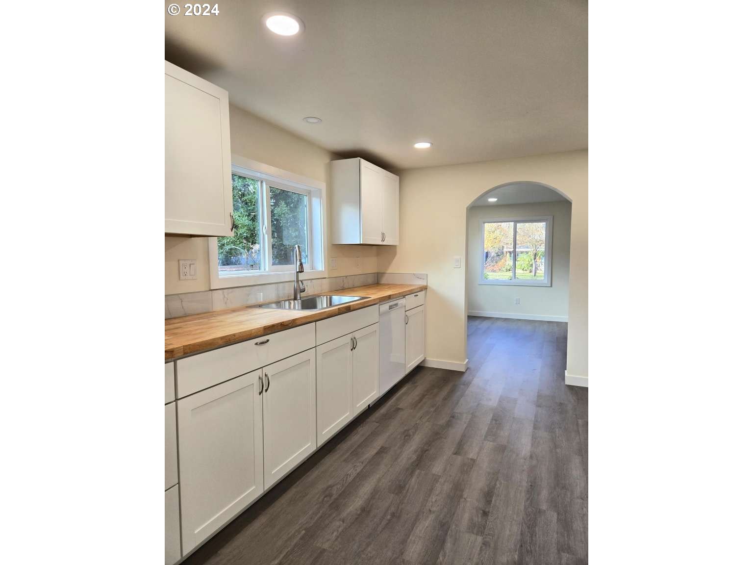 1223 C Street Springfield, OR 97477 - Photo 5 of 36 a large kitchen with cabinets wooden floor and a sink