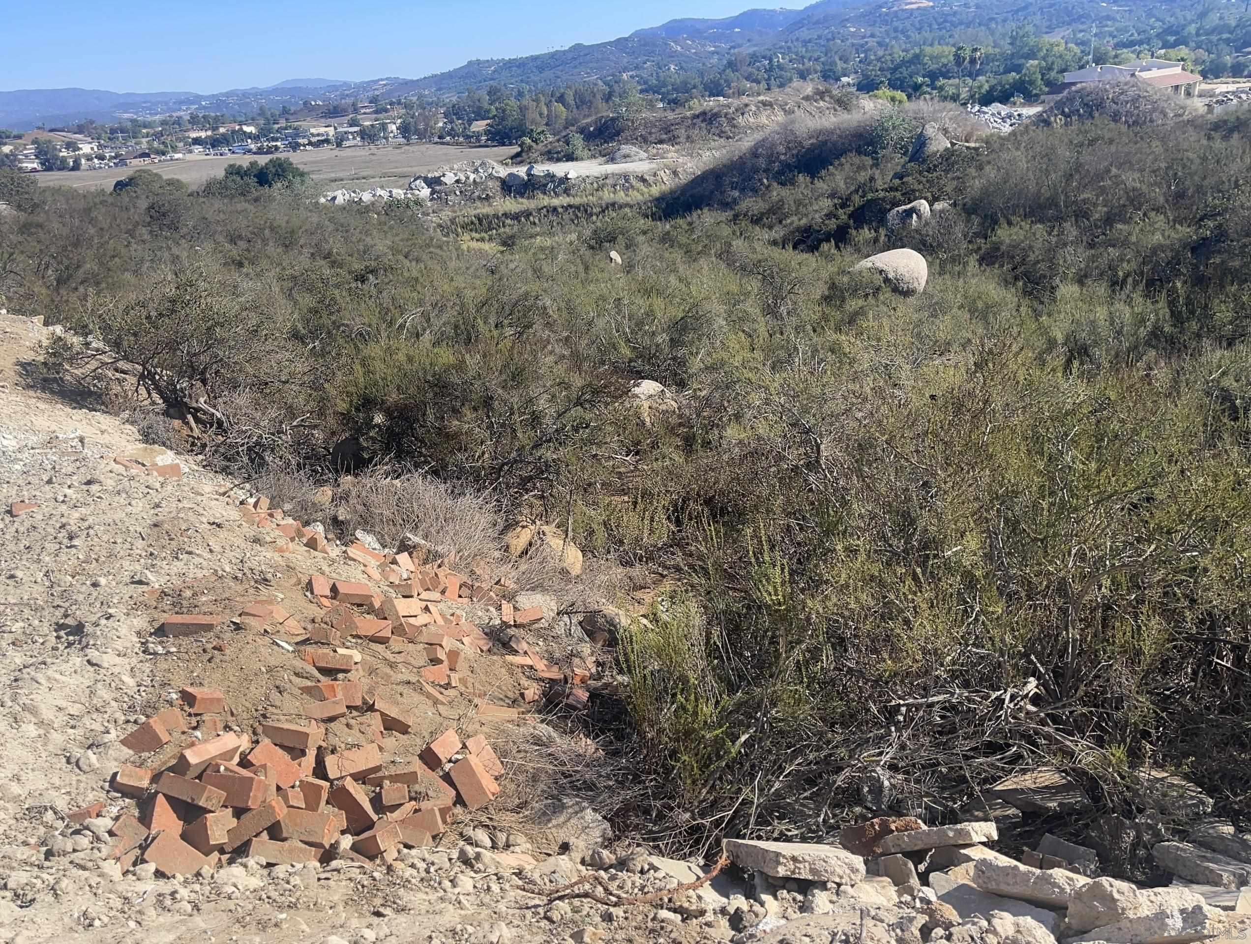 0 Miller Road Valley Center, CA 92082 - Photo 17 of 19 a view of a dry yard with trees and houses