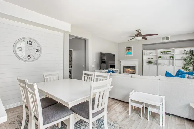 a view of a dining room with furniture and a clock