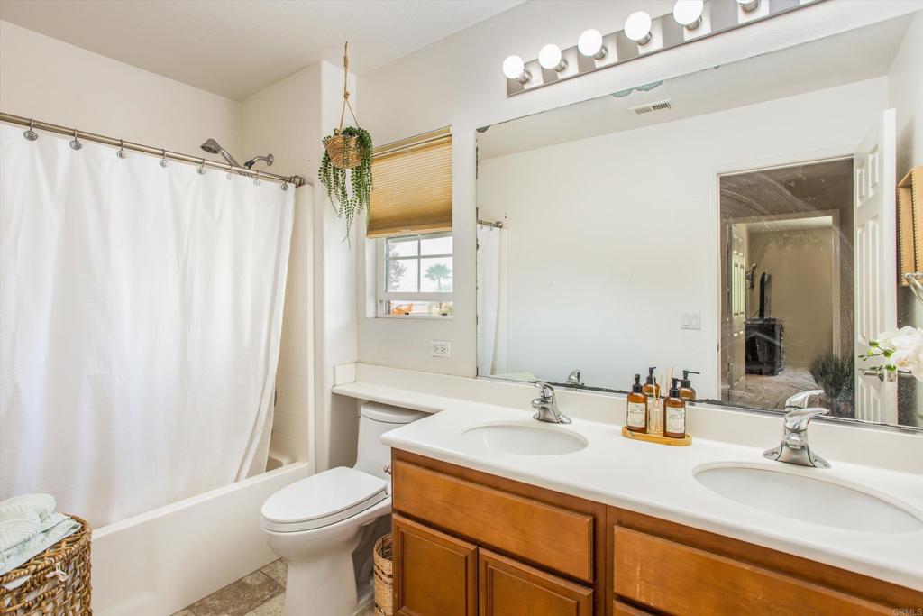 16478 Spirit Road Moreno Valley, CA 92555 - Photo 21 of 32 a bathroom with a sink vanity mirror and toilet