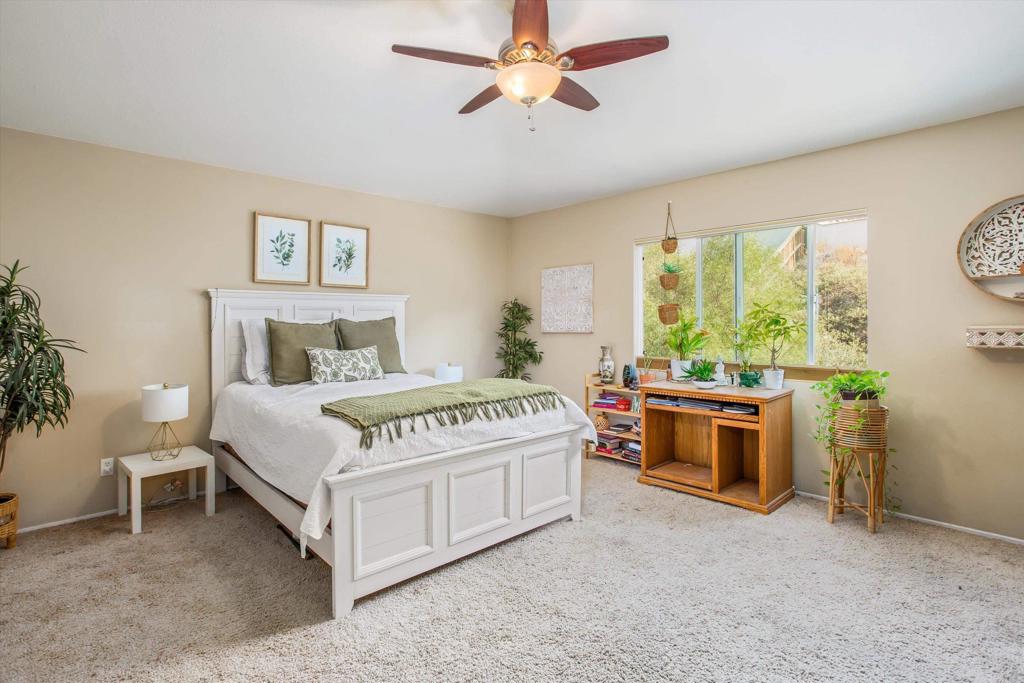 16478 Spirit Road Moreno Valley, CA 92555 - Photo 25 of 32 a bedroom with a large bed and a chandelier