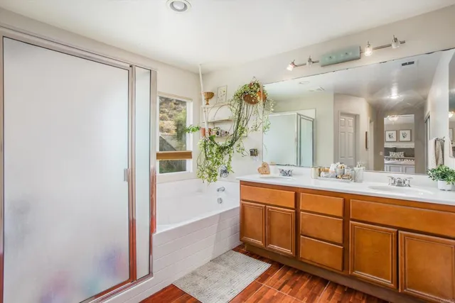 a bathroom with a tub sink and mirror