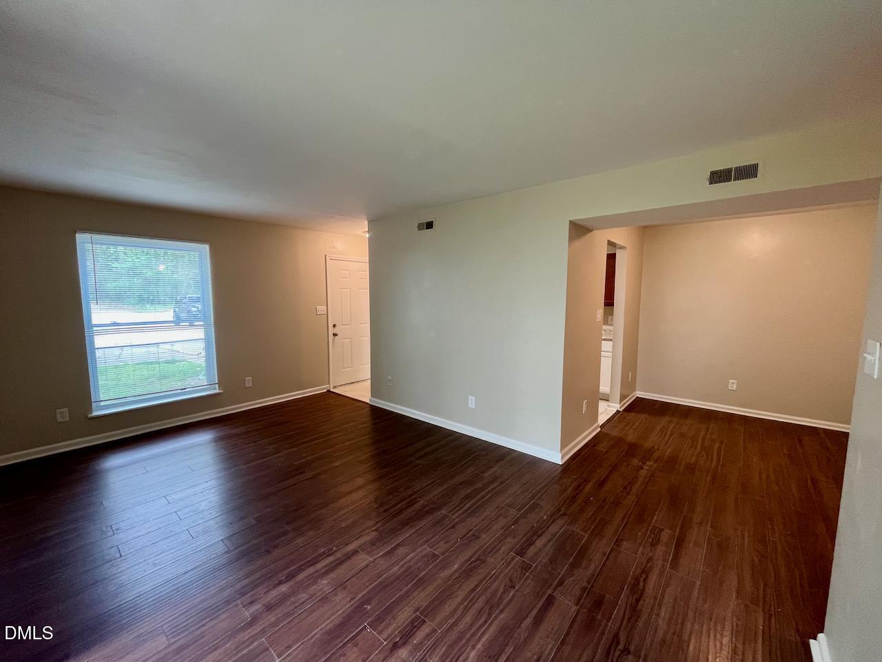4205 Greencastle Court, Unit D Raleigh, NC 27604 - Photo 4 of 13 an empty room with wooden floor and windows