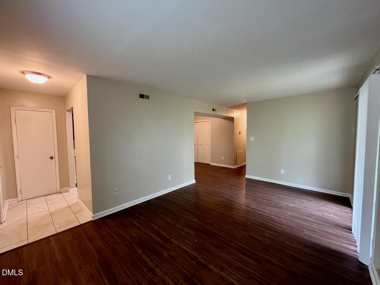 4205 Greencastle Court, Unit D Raleigh, NC 27604 - Photo 5 of 13 a view of an empty room with wooden floor and closet