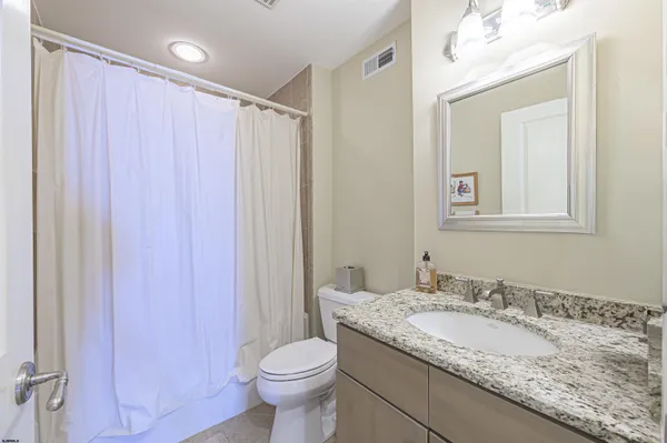 a living room with furniture a large window and a chandelier