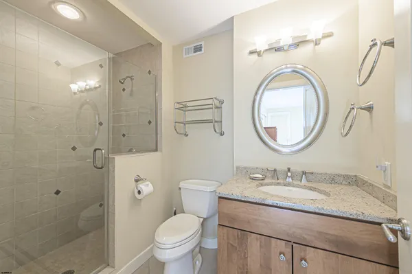 a living room with furniture a fireplace and a large window