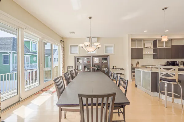 a living room with furniture a rug kitchen view and a table
