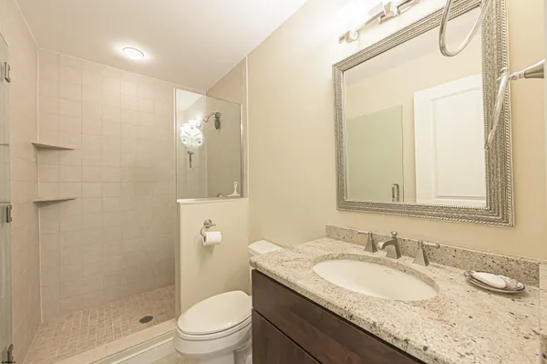 a large bed sitting in a bedroom next to a window