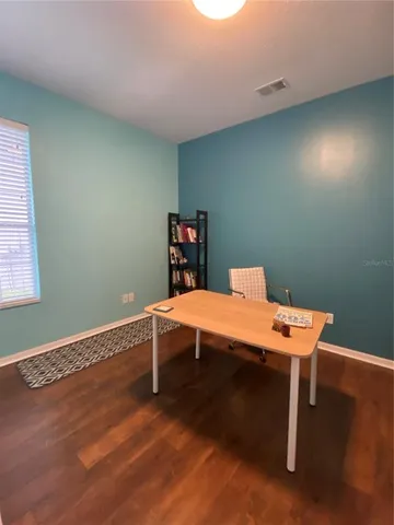 a living room with furniture gym equipment and a large window