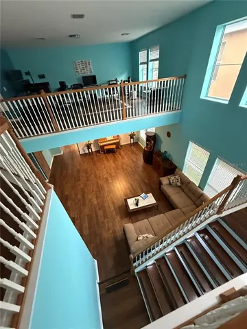 a room with wooden floor and white walls