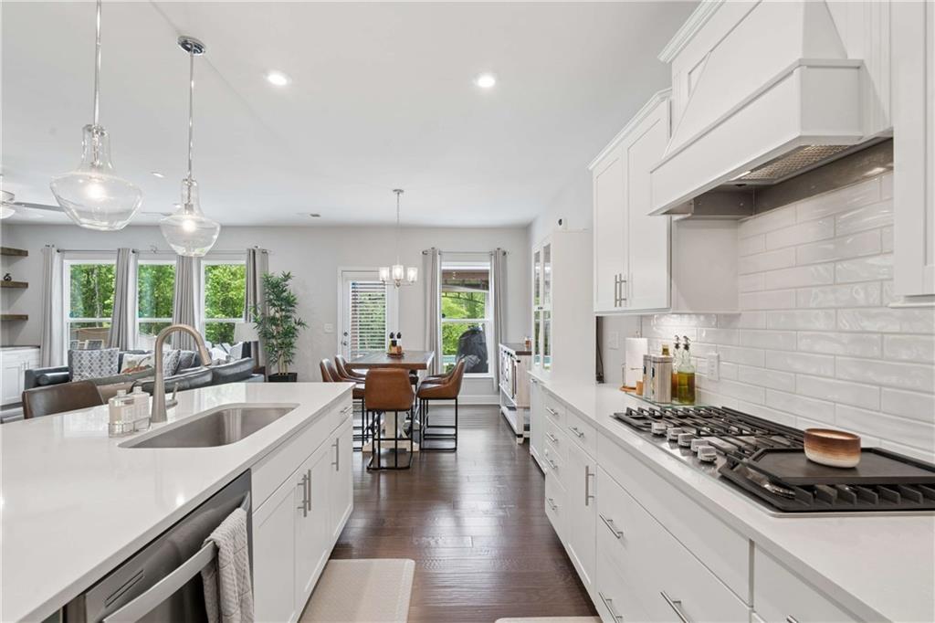 6168 Collins Road Acworth, GA 30101 - Photo 11 of 41 a kitchen with stainless steel appliances a stove a sink a oven a dining table and chairs