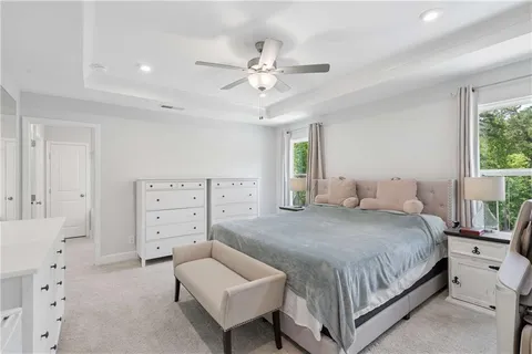 a bedroom with a bed and ceiling fan