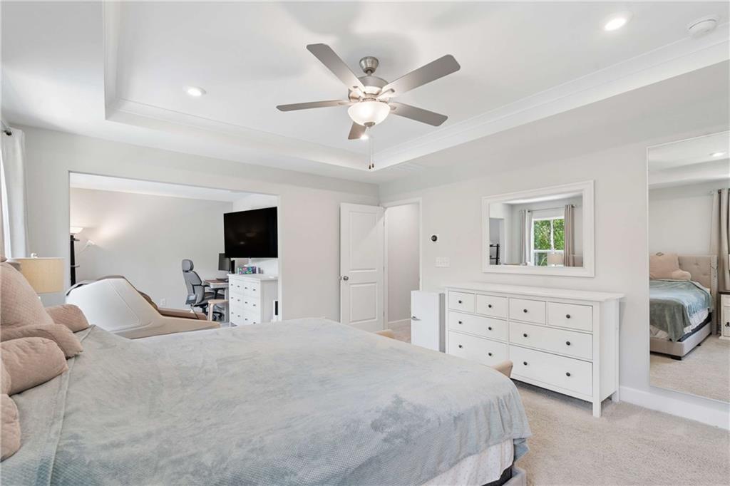 6168 Collins Road Acworth, GA 30101 - Photo 15 of 41 a bedroom with a bed a chandelier and a dresser