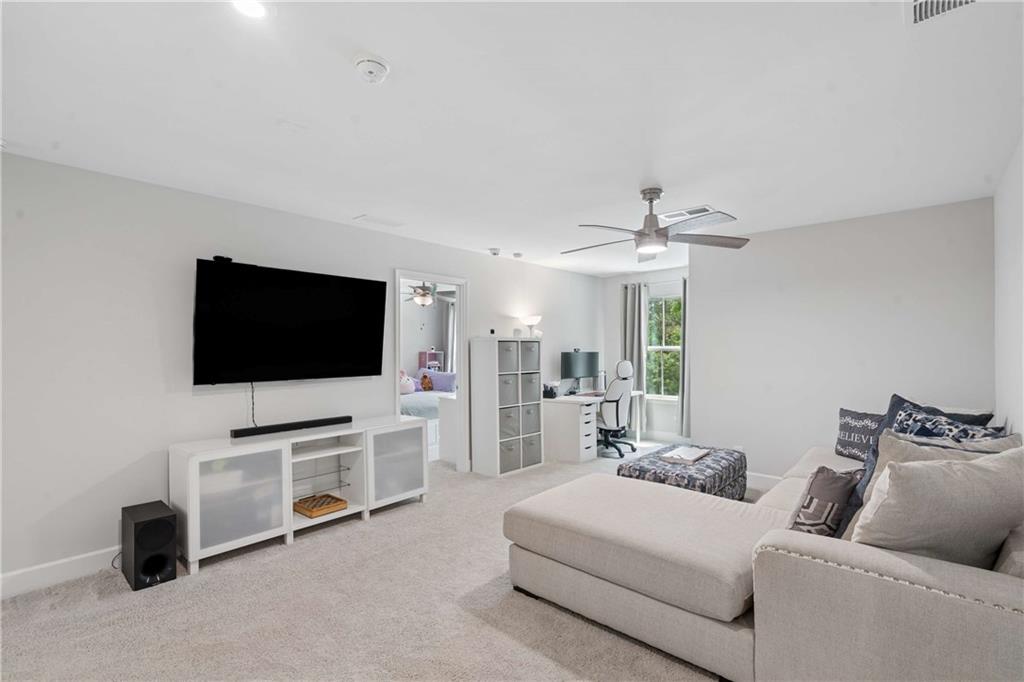 6168 Collins Road Acworth, GA 30101 - Photo 16 of 41 a living room with furniture and a flat screen tv