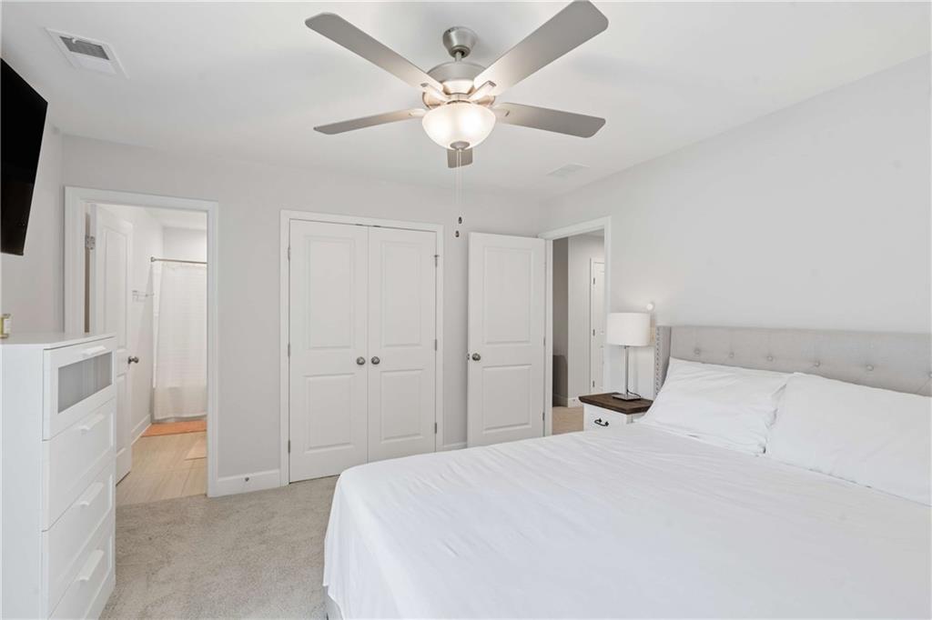 6168 Collins Road Acworth, GA 30101 - Photo 19 of 41 a bedroom with a bed and a chandelier