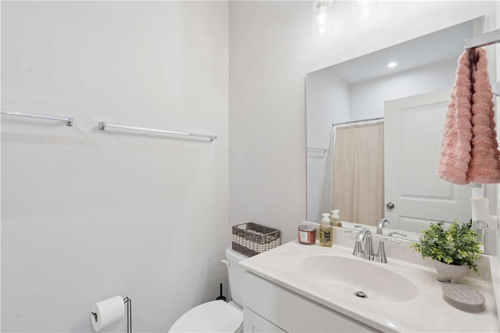 6168 Collins Road Acworth, GA 30101 - Photo 20 of 41 a bathroom with a sink mirror vanity and toilet