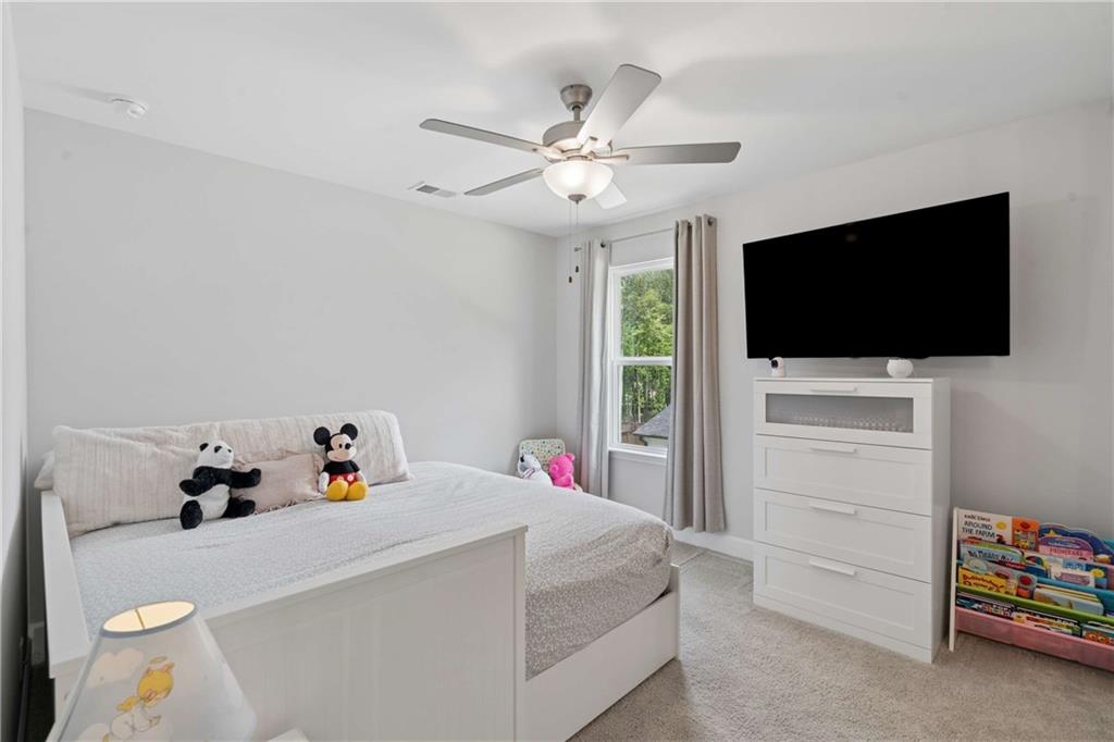 6168 Collins Road Acworth, GA 30101 - Photo 22 of 41 a bedroom with a bed and a flat screen tv
