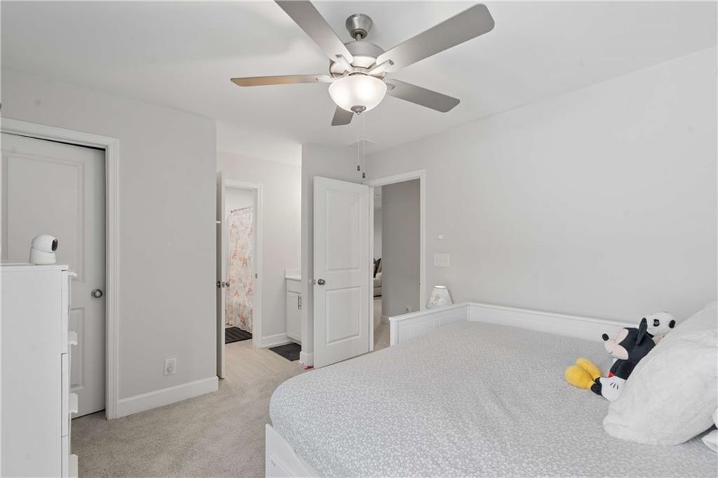 6168 Collins Road Acworth, GA 30101 - Photo 23 of 41 a spacious bedroom with a bed and ceiling fan