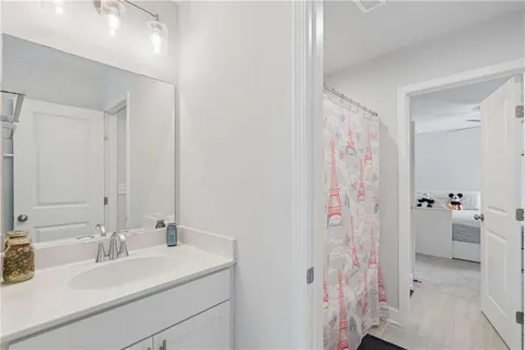 a bathroom with a sink vanity tub and shower