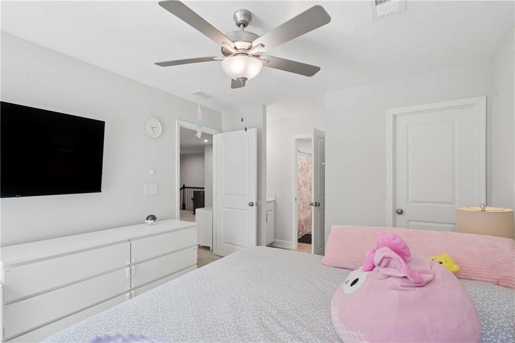 6168 Collins Road Acworth, GA 30101 - Photo 25 of 41 a bedroom with a bed and a flat screen tv