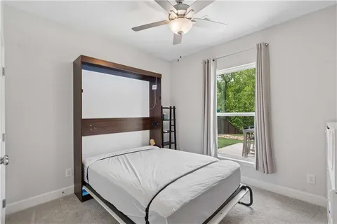 a bedroom with a bed and window