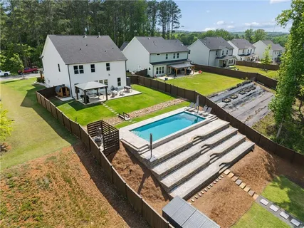 a view of a house with pool and chairs