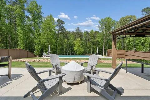 a view of backyard with seating area and green space