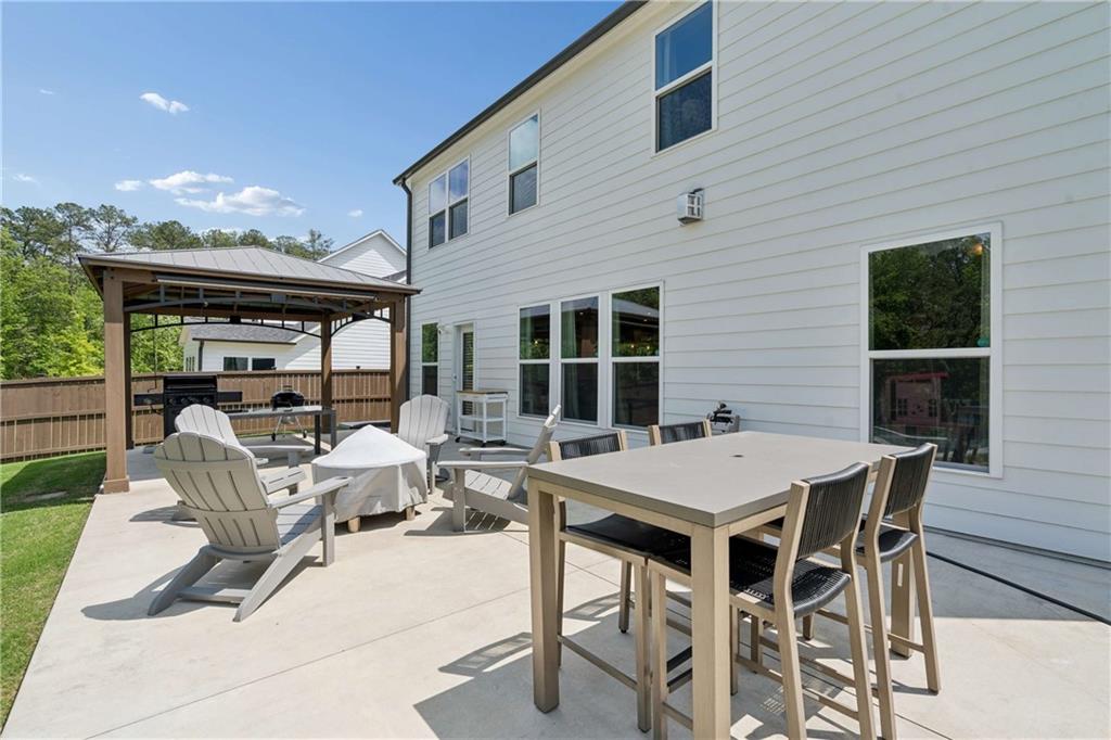 6168 Collins Road Acworth, GA 30101 - Photo 33 of 41 a view of a patio with a table and chairs