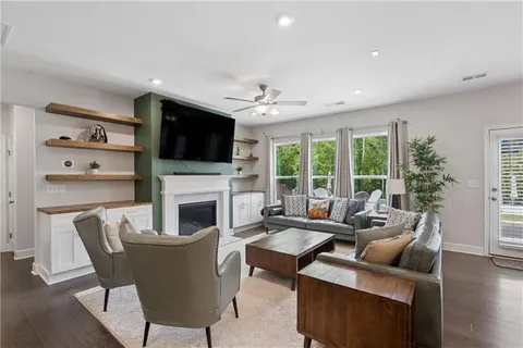 a living room with furniture a fireplace and a flat screen tv