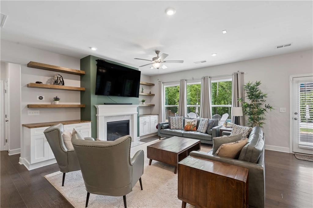 6168 Collins Road Acworth, GA 30101 - Photo 6 of 41 a living room with furniture a fireplace and a flat screen tv