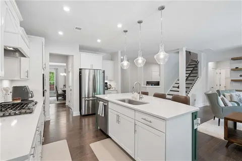a kitchen with a sink stainless steel appliances and cabinets