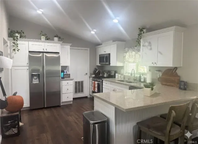 a kitchen with stainless steel appliances a refrigerator sink and stove