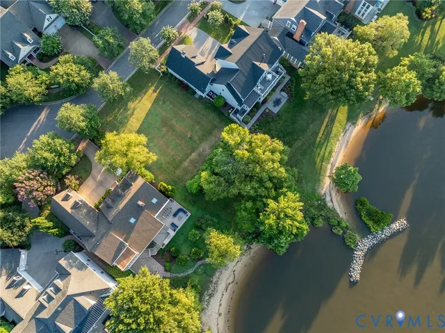 an aerial view of a house with lake view