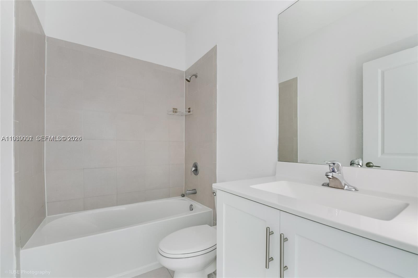 1705 Southeast 27th Street Homestead, FL 33035 - Photo 12 of 17 a bathroom with a bathtub shower sink vanity mirror and toilet