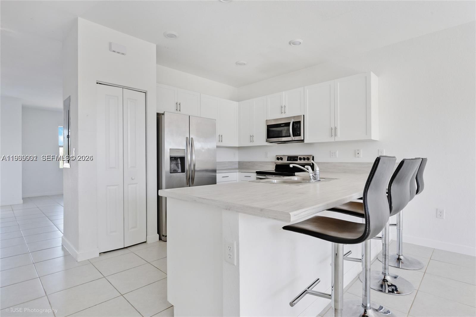 1705 Southeast 27th Street Homestead, FL 33035 - Photo 3 of 17 a kitchen with stainless steel appliances a refrigerator stove microwave and cabinets