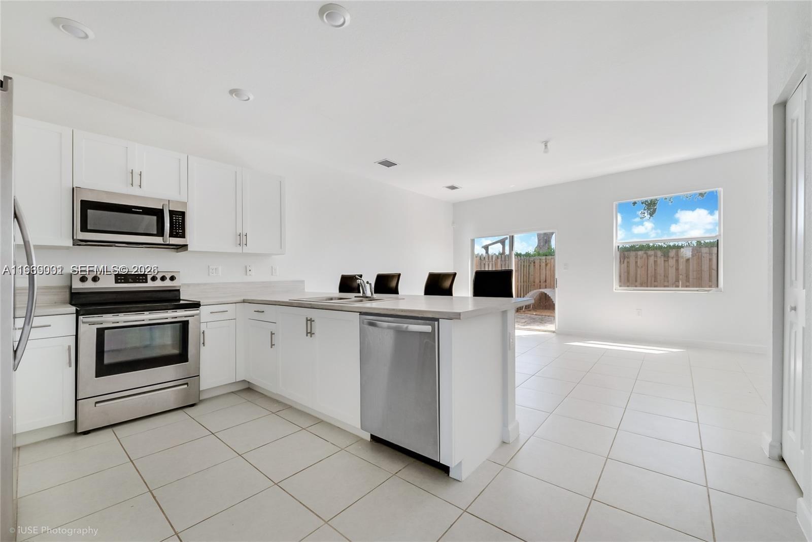 1705 Southeast 27th Street Homestead, FL 33035 - Photo 4 of 17 a kitchen with cabinets and appliances