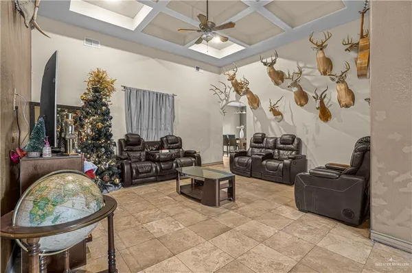 a living room with patio furniture and a chandelier