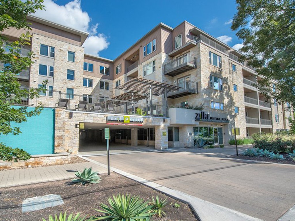 1900 Barton Springs Road, Unit 3040 Austin, TX 78704 - Photo 6 of 38 Multi-story building with stone and siding exterior, featuring multiple balconies with metal railings