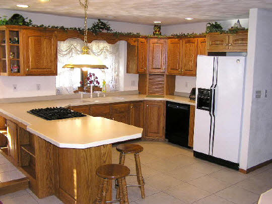 8625 McCurry Road Roscoe, IL 61073 - Photo 3 of 6 a kitchen with stainless steel appliances granite countertop a sink a refrigerator and a stove