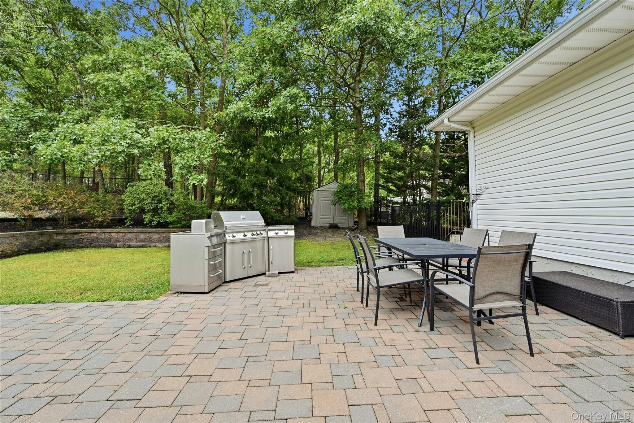 16 Georgann Road Manorville, NY 11949 - Photo 24 of 32 Back yard dining area and barbeque.