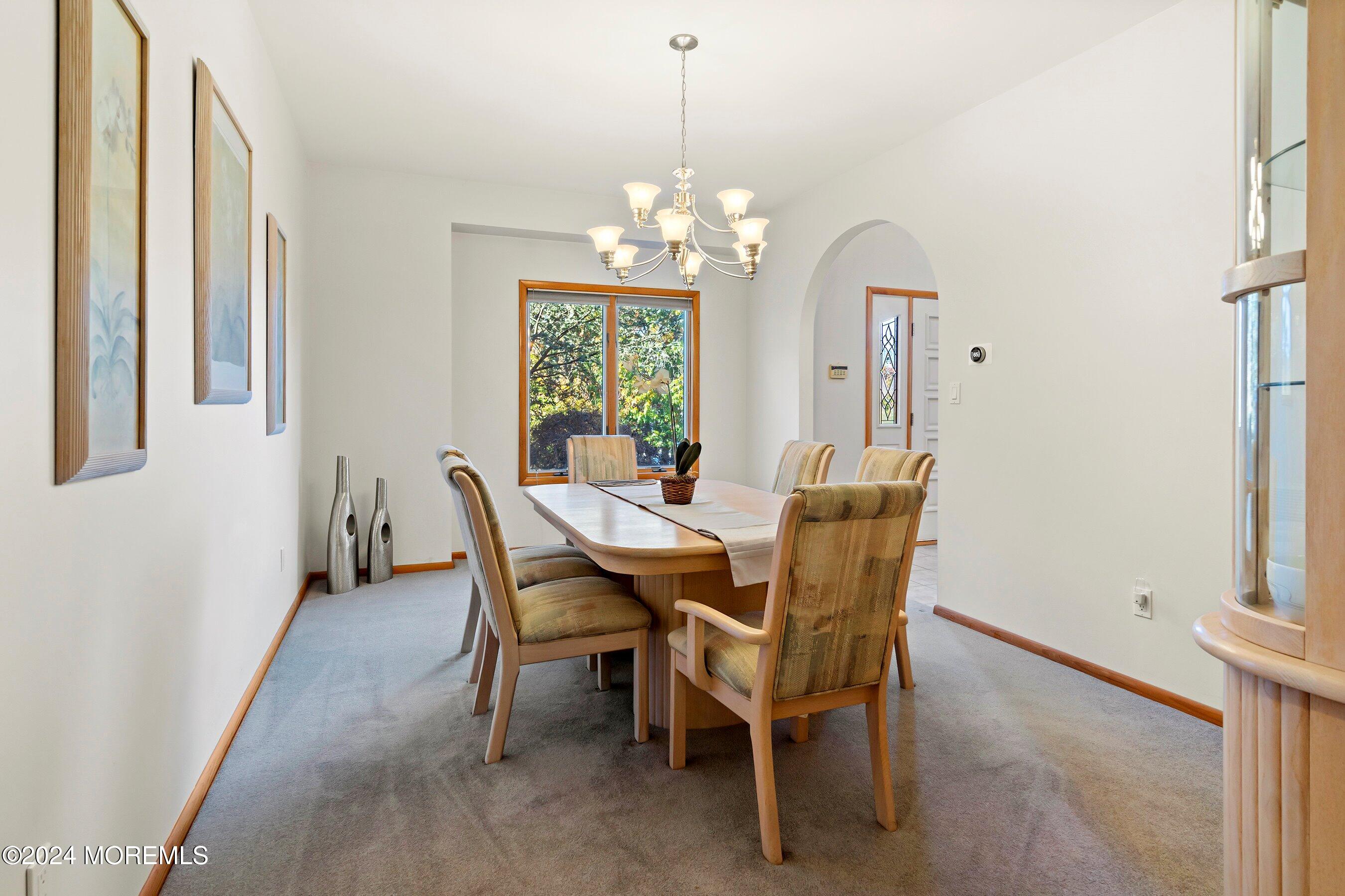 742 Rabbit Run Brick, NJ 08724 - Photo 13 of 51 a dining room with furniture a chandelier and a window