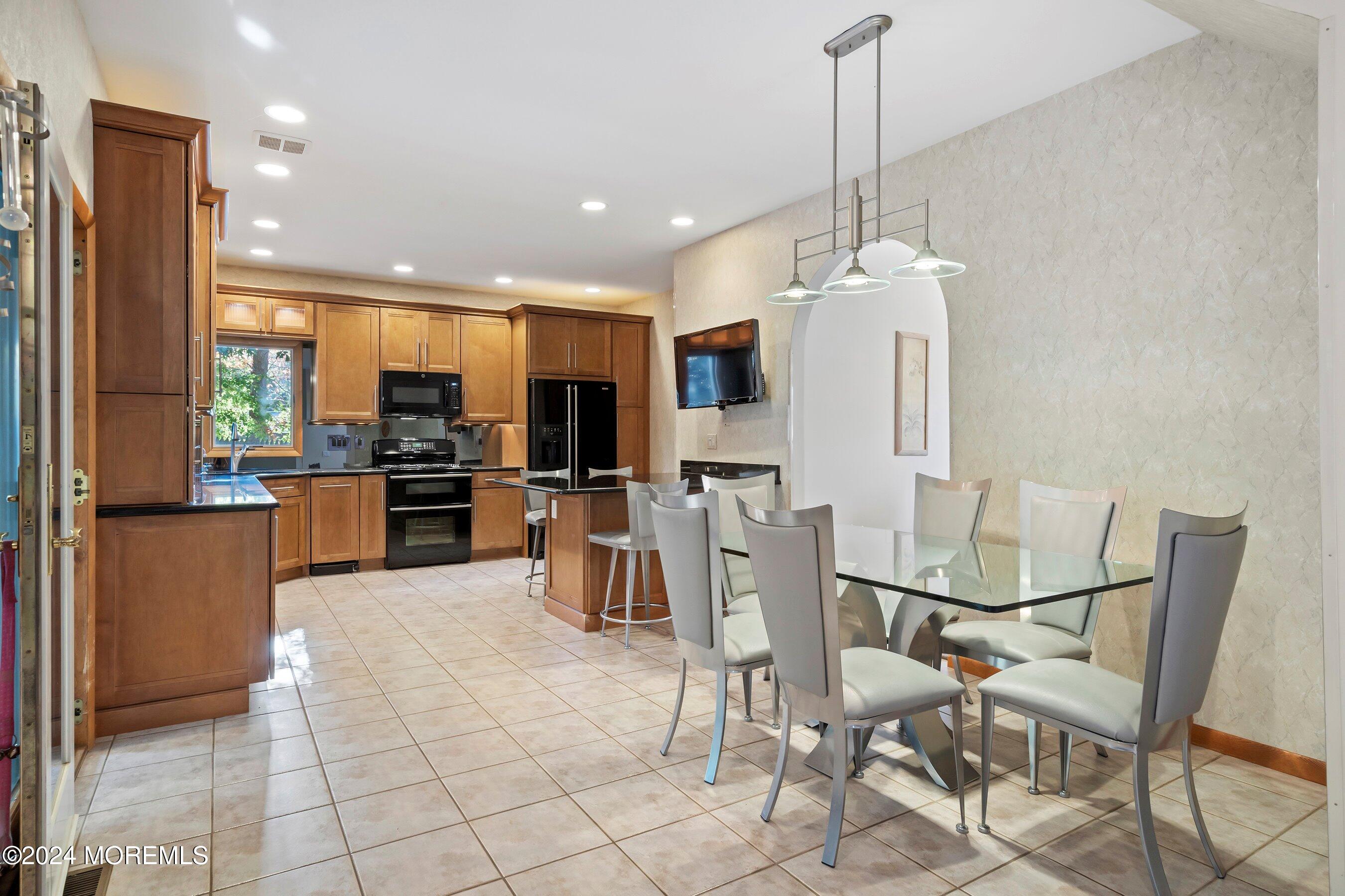 742 Rabbit Run Brick, NJ 08724 - Photo 16 of 51 a kitchen with stainless steel appliances kitchen island granite countertop a refrigerator and microwave