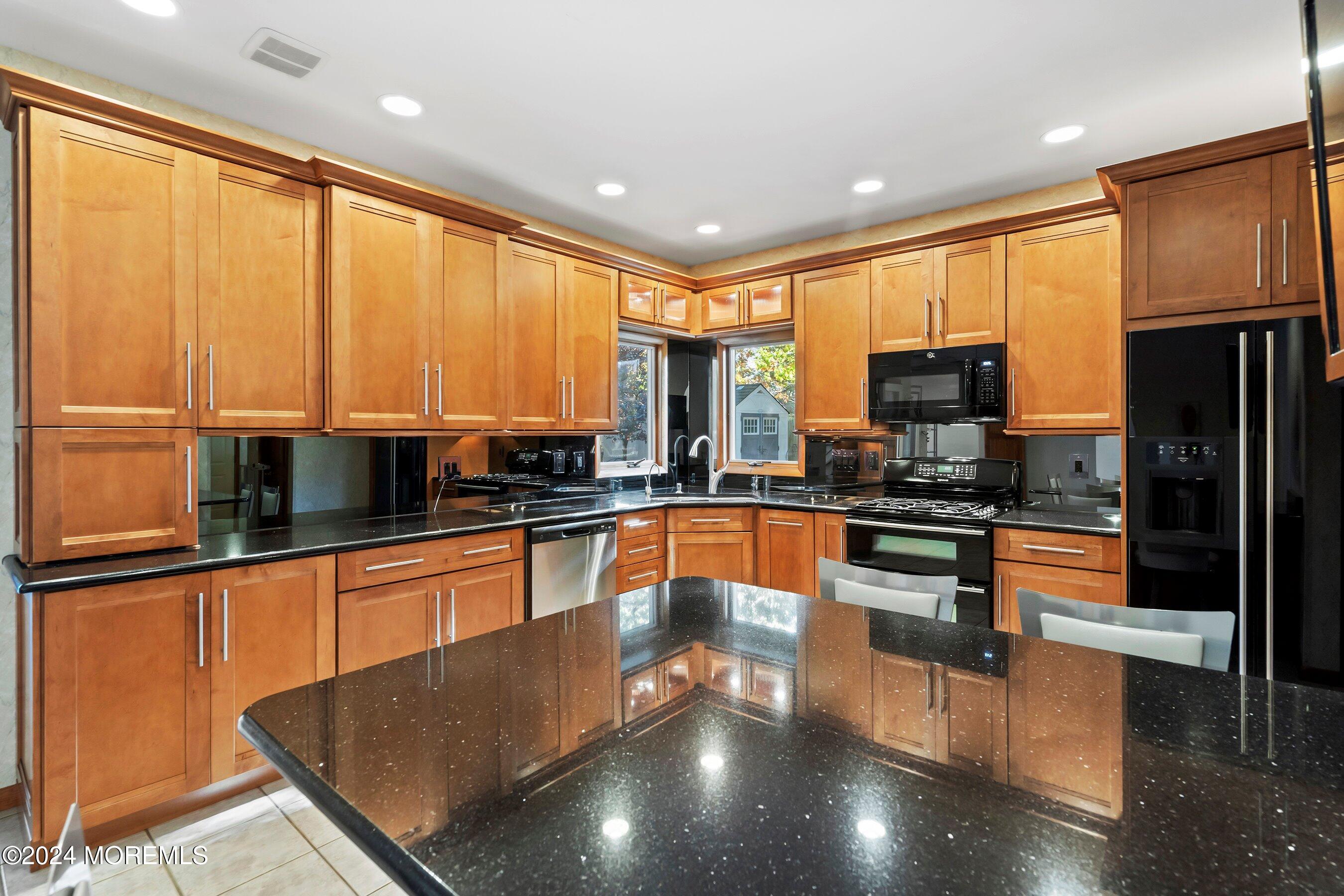 742 Rabbit Run Brick, NJ 08724 - Photo 18 of 51 a kitchen with stainless steel appliances wooden cabinets and a refrigerator