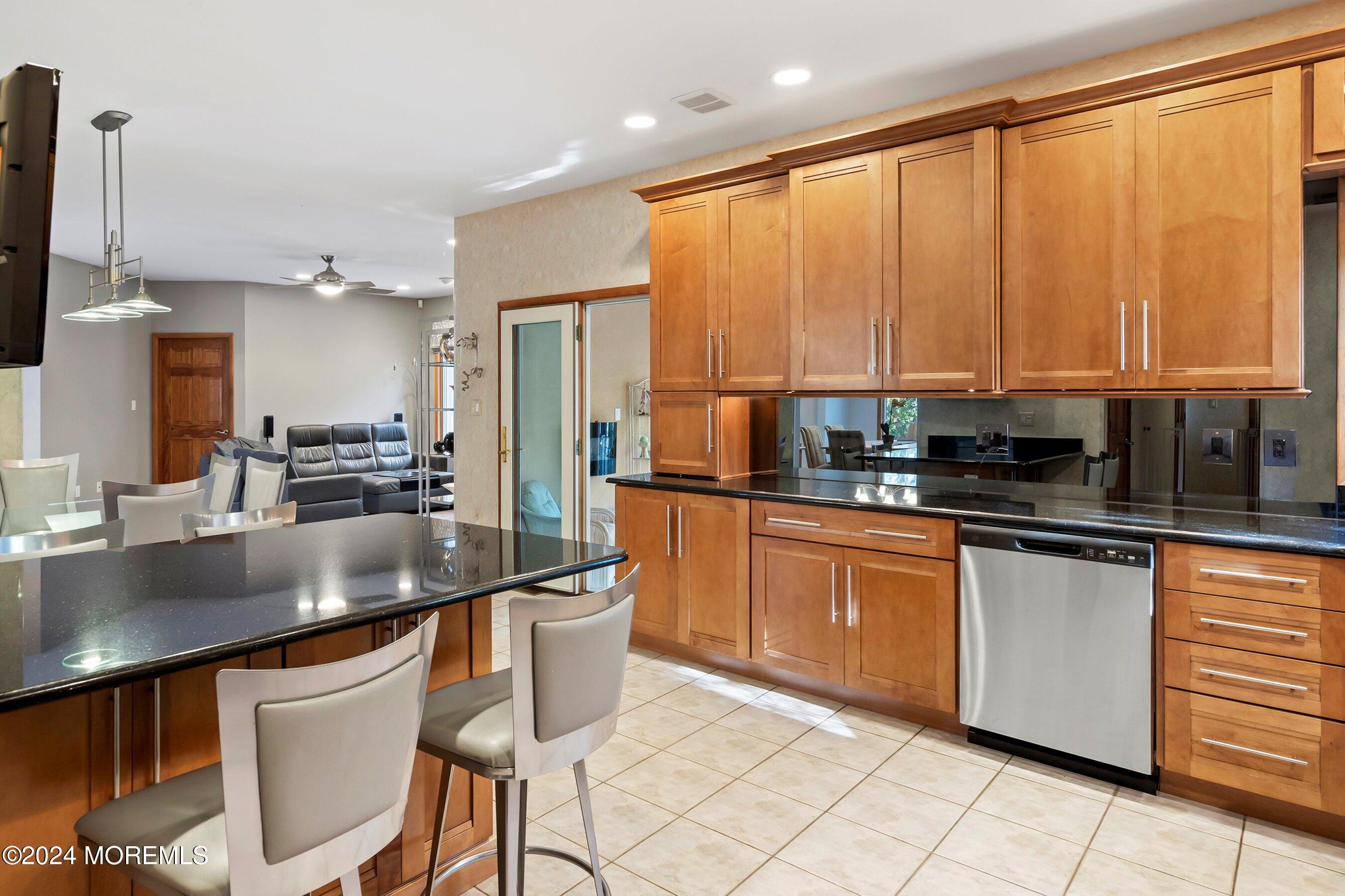 742 Rabbit Run Brick, NJ 08724 - Photo 21 of 51 a kitchen with stainless steel appliances kitchen island granite countertop a sink and cabinets